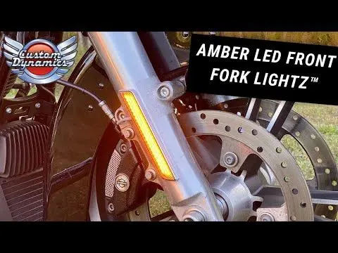 A close up of the front fork lights on a motorcycle