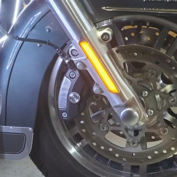 A motorcycle tire with yellow lights on it.