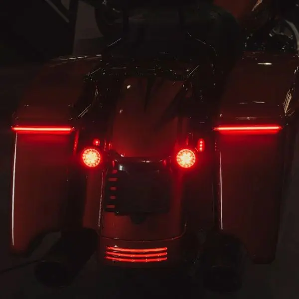 A motorcycle with its tail lights on.