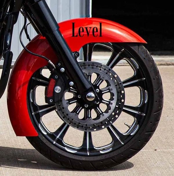 A red motorcycle wheel with the word " level " on it.