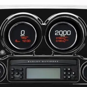 A car dashboard with two gauges and a radio.