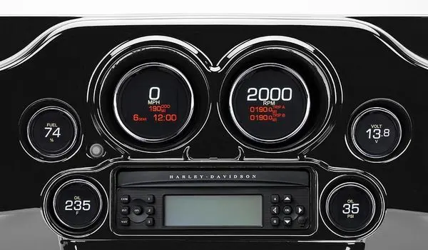 A car dashboard with two gauges and a radio.