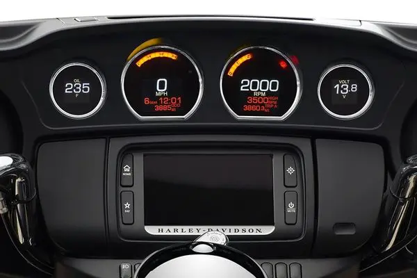 A close up of the dashboard and gauges on a harley davidson motorcycle.