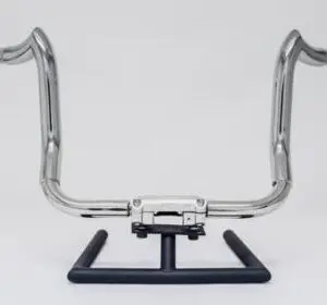 A motorcycle handlebar with the seat up.
