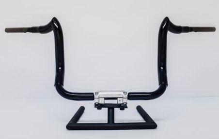 A black handlebar with chrome bars on the end of it.