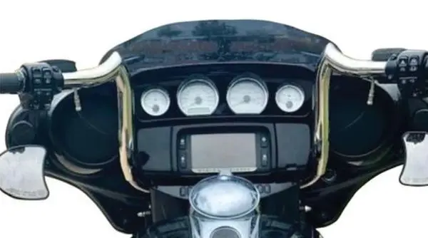 A close up of the dashboard and gauges on a motorcycle.