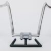 A motorcycle handlebar with a chrome frame on top of it.