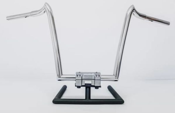 A motorcycle handlebar with a chrome frame on top of it.