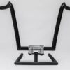 A black handlebar with a silver handle sitting on top of it.