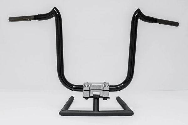 A black handlebar with a silver handle on it