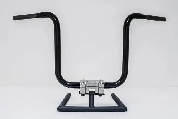 A pair of handlebars sitting on top of a metal stand.