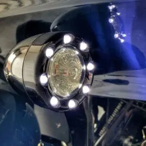 A close up of the front light on a motorcycle