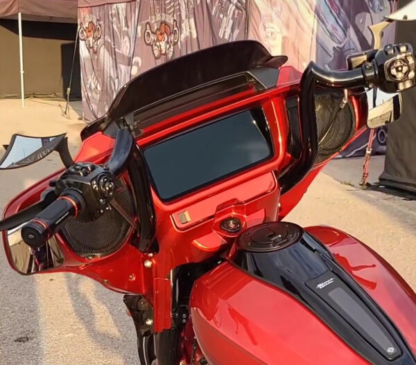 Red motorcycle with black handlebars and mirrors.