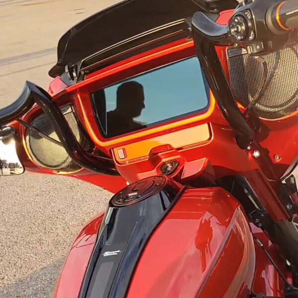 Red motorcycle with black handlebars and speakers.