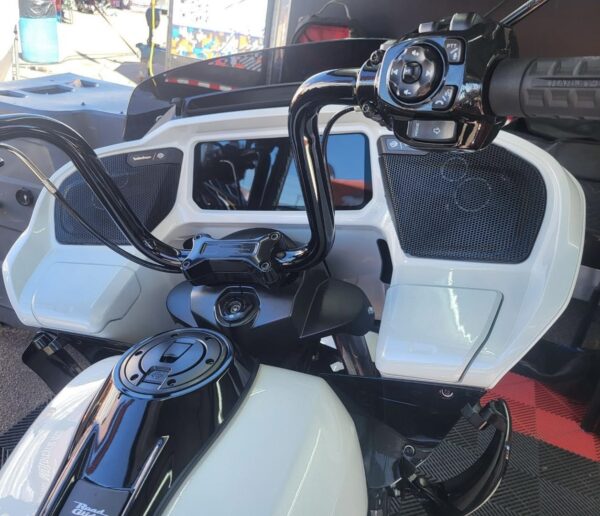 White motorcycle with black handlebars and speakers.