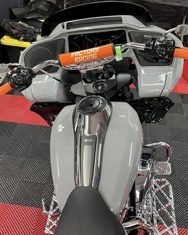 Gray motorcycle with factory racing grips.