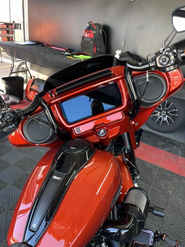 A Red Color Motorcycle Body With Black Details.