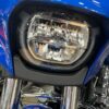 Close-up of a blue motorcycle headlight.