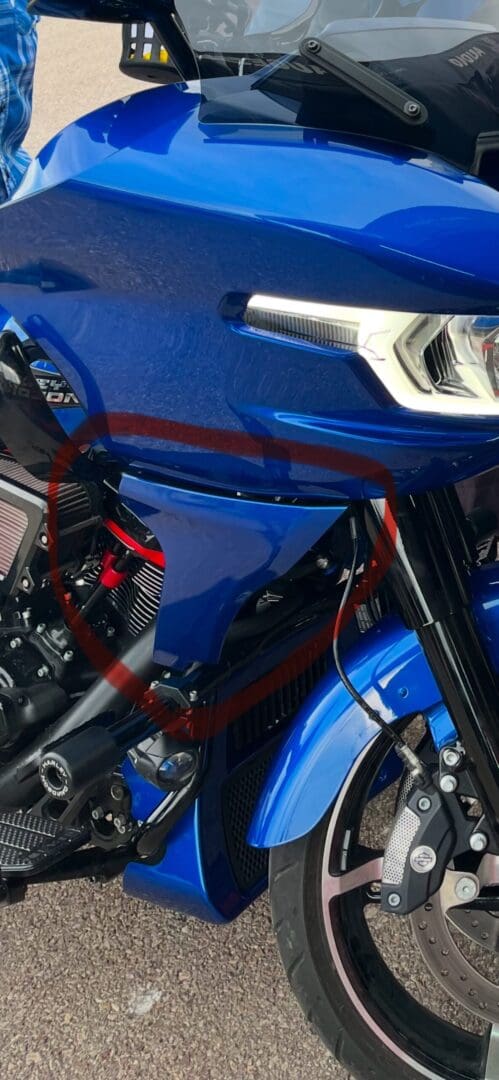 Blue touring motorcycle headlight and fork close-up
